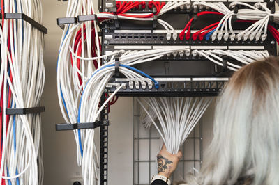 Female electrician managing cables