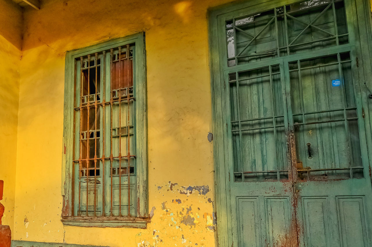 CLOSED DOOR OF YELLOW BUILDING