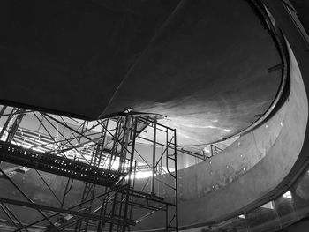 Low angle view of illuminated lighting equipment against sky