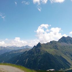 Scenic view of mountains against cloudy sky
