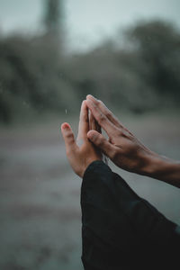 The hands of a pair of lovers touch and hold aech other