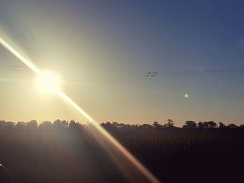 Scenic view of field against sky at sunset