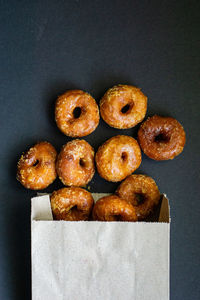 Directly above shot of donuts against black background