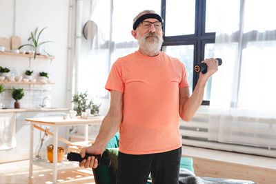 Portrait of young man exercising in gym