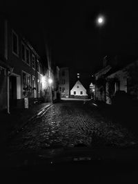 Illuminated city against sky at night