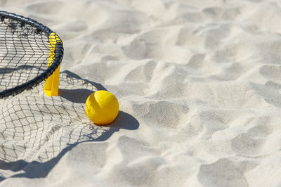 High angle view of yellow ball on sand