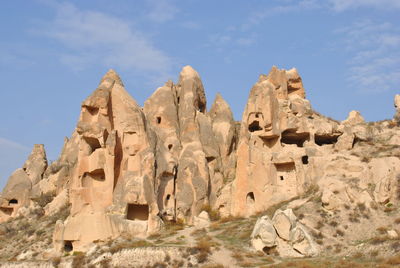 Low angle view of rock formation against sky