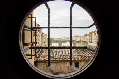 Buildings seen through circle window in city
