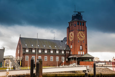 Low angle view of clock tower in city against sky