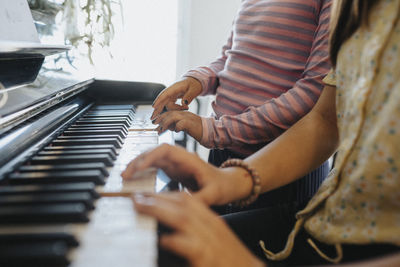 Sisters bonding over playing piano together