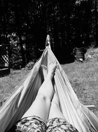 Low section of woman relaxing on hammock