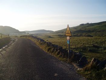 Narrow road along countryside landscape