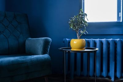 Empty chairs and table against wall at home