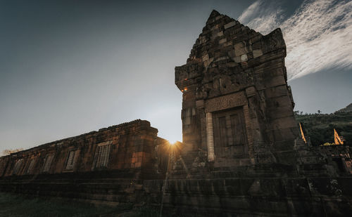 Low angle view of old building against sky during sunset