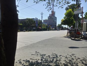 Road by city against sky