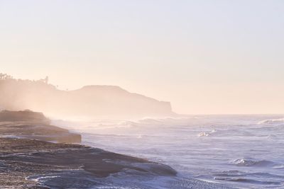 Scenic view of sea against clear sky during sunset