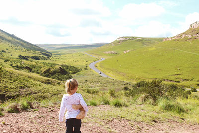 Rear view of woman looking at mountains