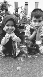 Portrait of cute girl sitting outdoors