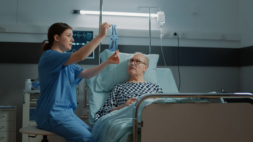 Nurse showing medical x-ray to patient