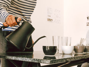 Midsection of woman preparing food on table