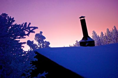 Silhouette trees against clear sky during sunset