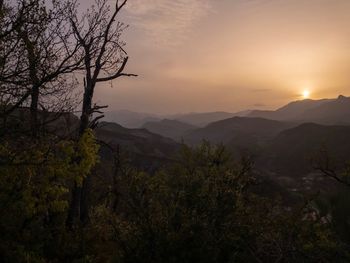 Scenic view of silhouette mountains against sky at sunset