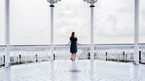 Rear view of woman standing against sky