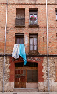 Low angle view of clothes drying against building