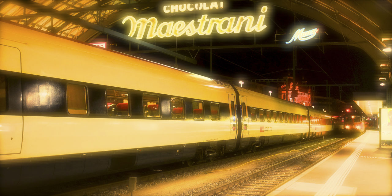 illuminated, night, transportation, rail transportation, reflection, public transportation, railroad station platform, communication, railroad station, no people, built structure, indoors, architecture