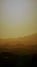 Scenic view of silhouette mountains against sky at sunset