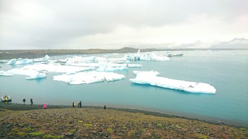 Scenic view of snow sea against sky during winter