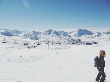 Tourists walking on snow covered landscape