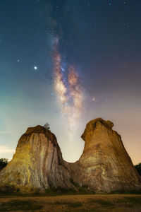 Low angle view of rock formation against sky