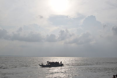 Boat sailing on river against sky