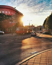 Cars on road in city against sky