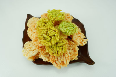 High angle view of food in plate against white background
