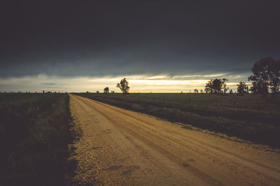 Scenic view of agricultural field against sky during sunset