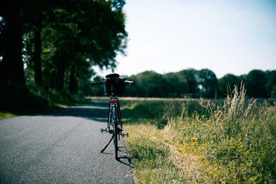 Bicycle on land against sky