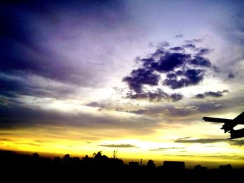 Low angle view of silhouette trees against sunset sky