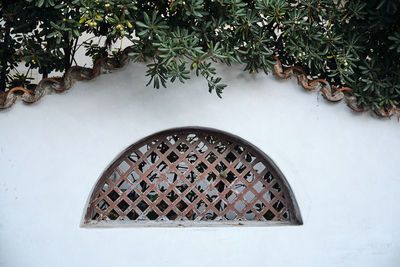 Text on window against white wall