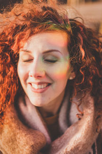 Close-up portrait of smiling young woman