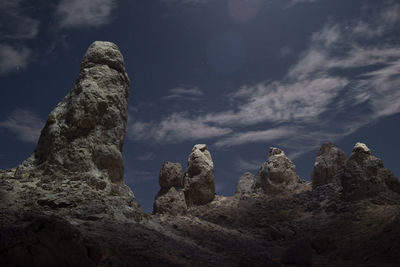 The pillars of trona illuminted from above on a starry night in