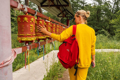 Rear view of woman standing in park