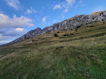 Scenic view of landscape and mountains against sky