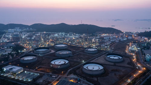 Aerial view industry factory oil and gas chemical tank and oil refinery and mountain at twilight