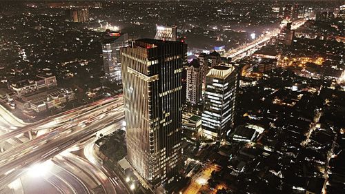 High angle view of illuminated modern buildings in city at night