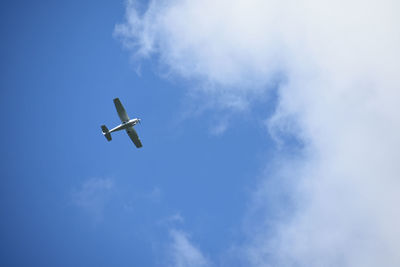 Low angle view of airplane flying in sky