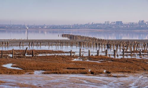 Scenic view of lake against sky during winter