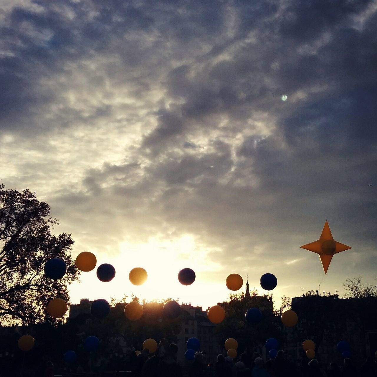 sky, sunset, cloud - sky, beauty in nature, cloudy, cloud, silhouette, nature, low angle view, scenics, tree, tranquility, orange color, outdoors, tranquil scene, dusk, landscape, field, yellow, idyllic