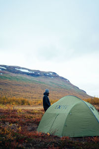 Rear view of tent on field against sky